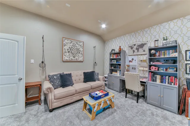 a living room with furniture and a book shelf
