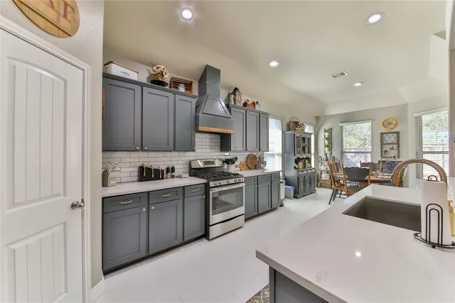 a kitchen with cabinets a sink and appliances