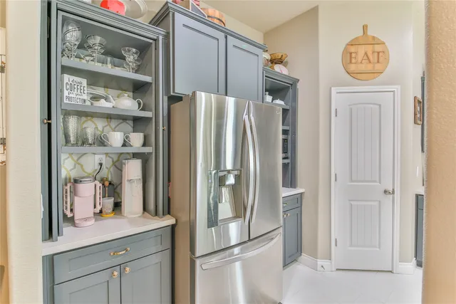 a kitchen with stainless steel appliances granite countertop a refrigerator and a cabinets