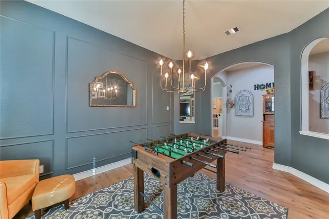 a view of a dining room with furniture and chandelier