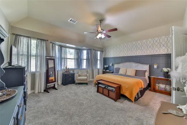 a bedroom with bed and a large window