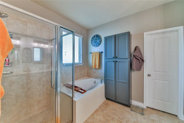 a bathroom with a tub and shower