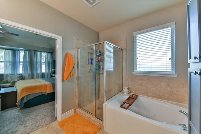 a bathroom with a tub a sink and a shower