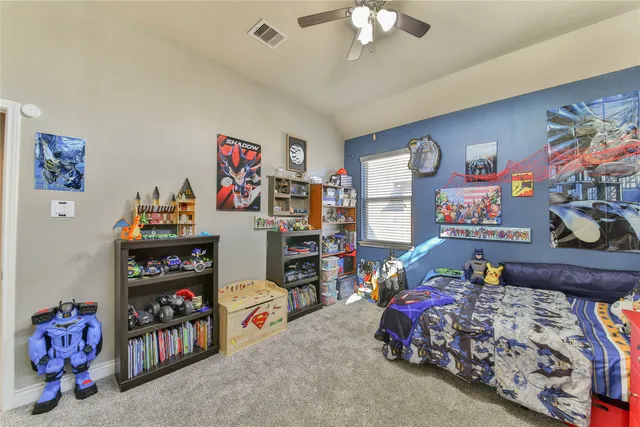 a bedroom with bed and wooden floor