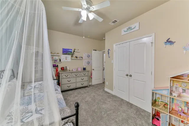 a view of a bedroom with baby crib and cabinet