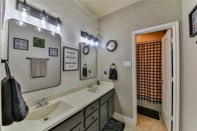 a bathroom with a sink vanity and a mirror