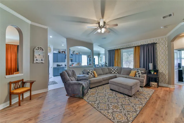 a living room with furniture and a chandelier