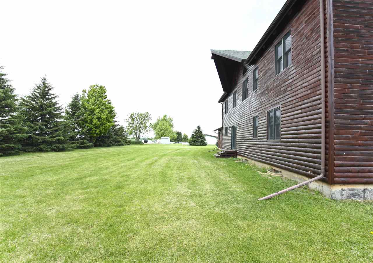 20100 Grade School Road Caledonia, IL 61011 - Photo 20 of 21 a backyard of a house with lots of green space