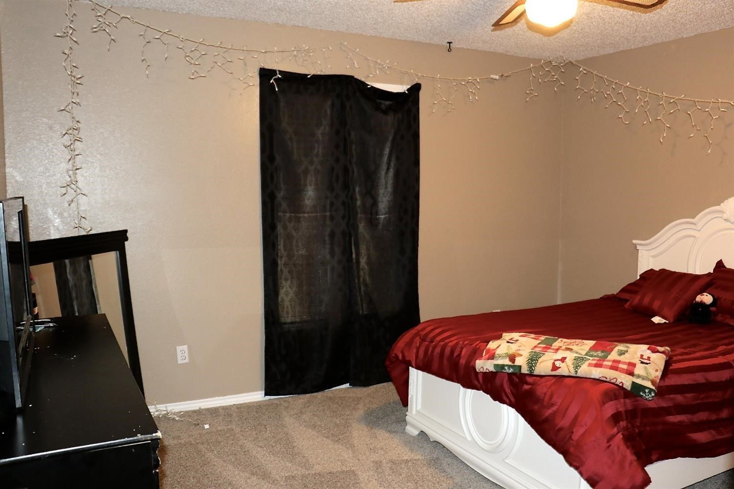 7004 Elkhart Avenue Lubbock, TX 79424 - Photo 10 of 16 a bedroom with a bed and a lamp on the dresser