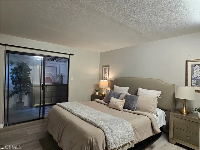 a bedroom with a bed and a large window