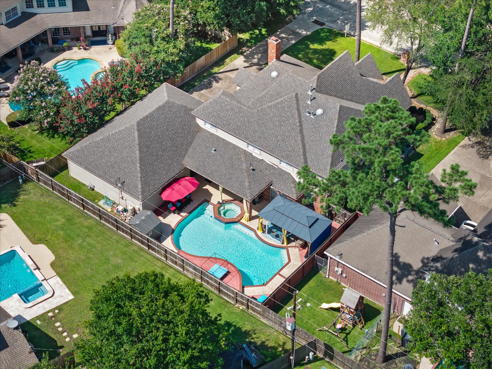 16123 Lafone Drive Spring, TX 77379 - Photo 2 of 47 From above, discover a true backyard oasis featuring a sparkling pool, relaxing spa, and pavilion—an exceptional outdoor retreat designed for both entertaining and everyday enjoyment.