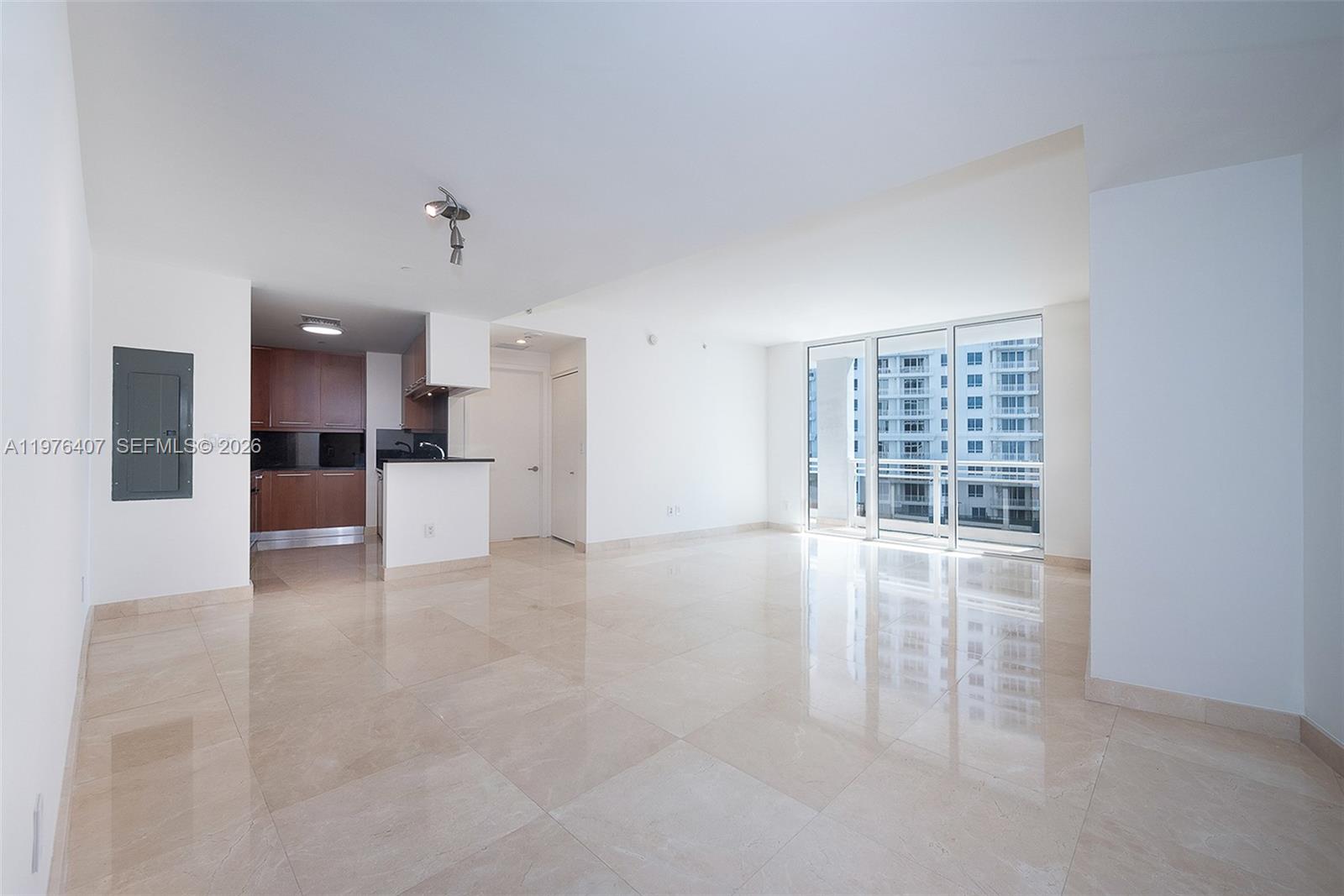 901 Brickell Key Boulevard, Unit 901 Miami, FL 33131 - Photo 11 of 35 a view of a kitchen with a refrigerator and a sink
