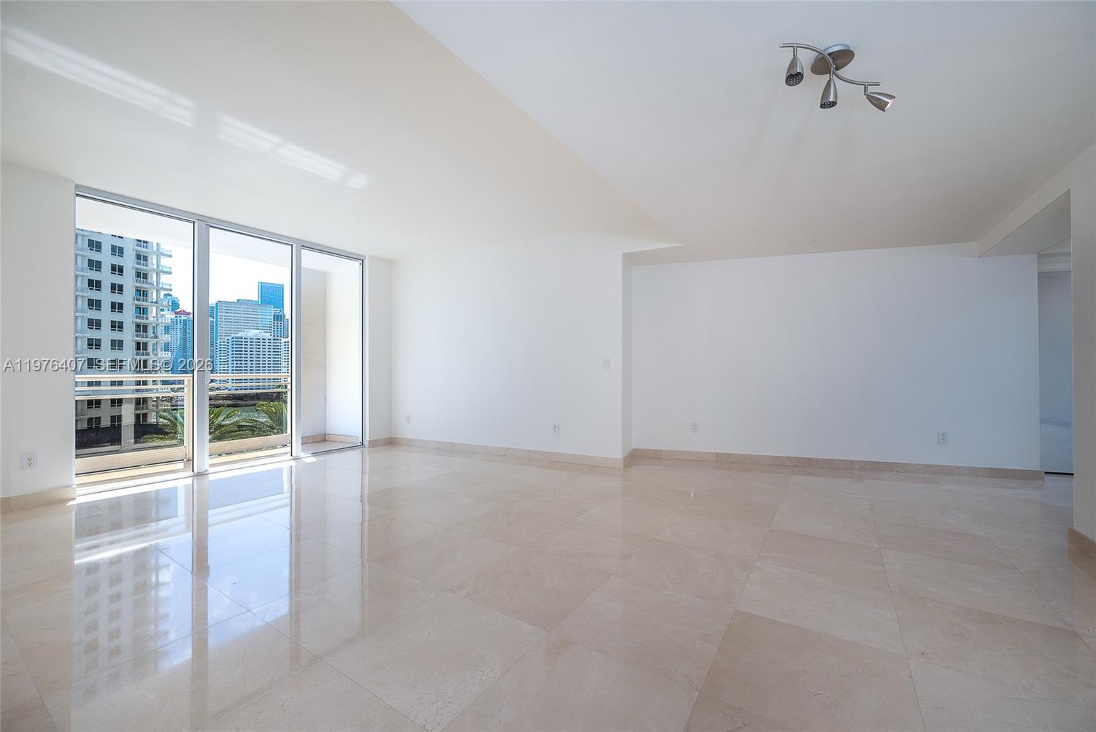 901 Brickell Key Boulevard, Unit 901 Miami, FL 33131 - Photo 12 of 35 an empty room with windows