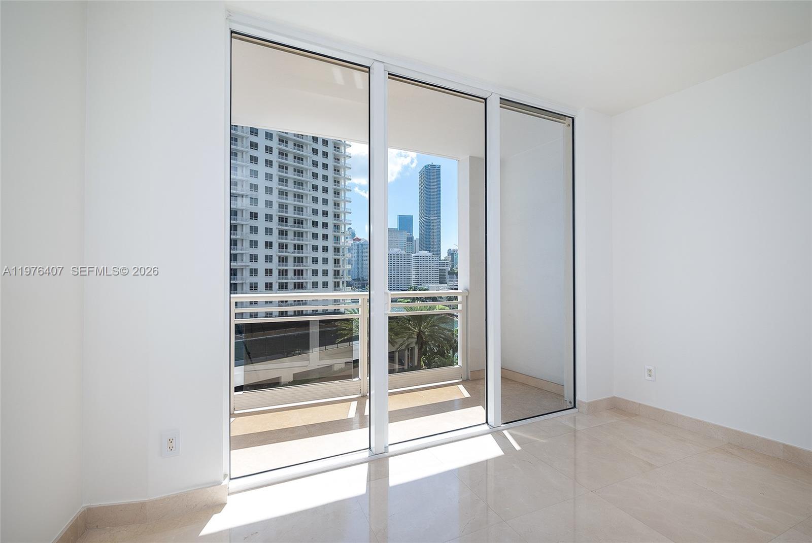 901 Brickell Key Boulevard, Unit 901 Miami, FL 33131 - Photo 15 of 35 a view of an empty room with a window