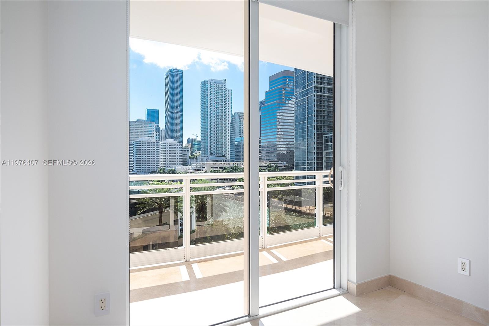 901 Brickell Key Boulevard, Unit 901 Miami, FL 33131 - Photo 17 of 35 a kitchen view with a sink and view of living room