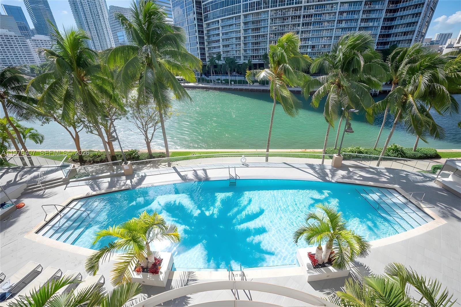 901 Brickell Key Boulevard, Unit 901 Miami, FL 33131 - Photo 23 of 35 a view of a swimming pool with a patio