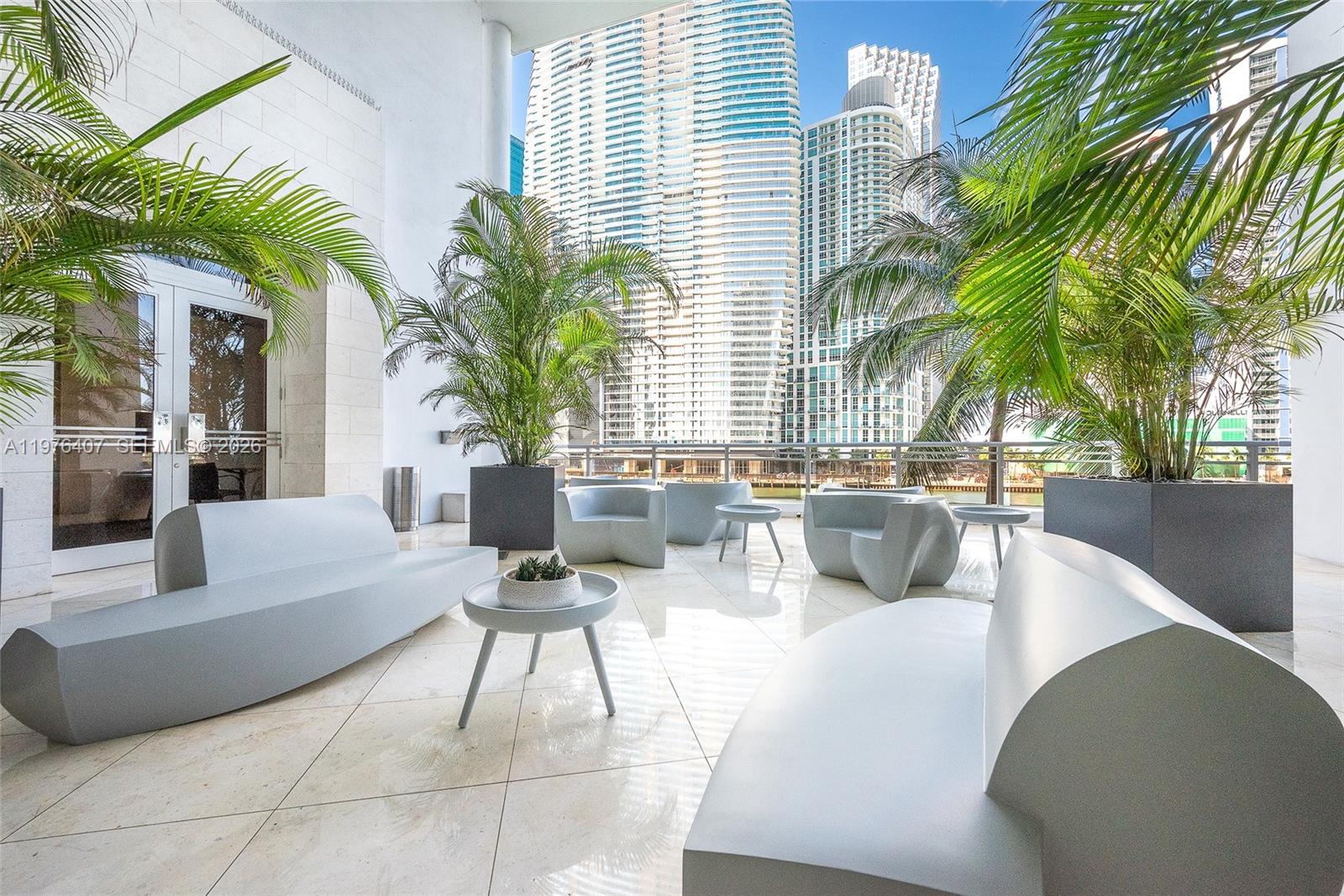 901 Brickell Key Boulevard, Unit 901 Miami, FL 33131 - Photo 30 of 35 a living room with patio furniture and a potted plant