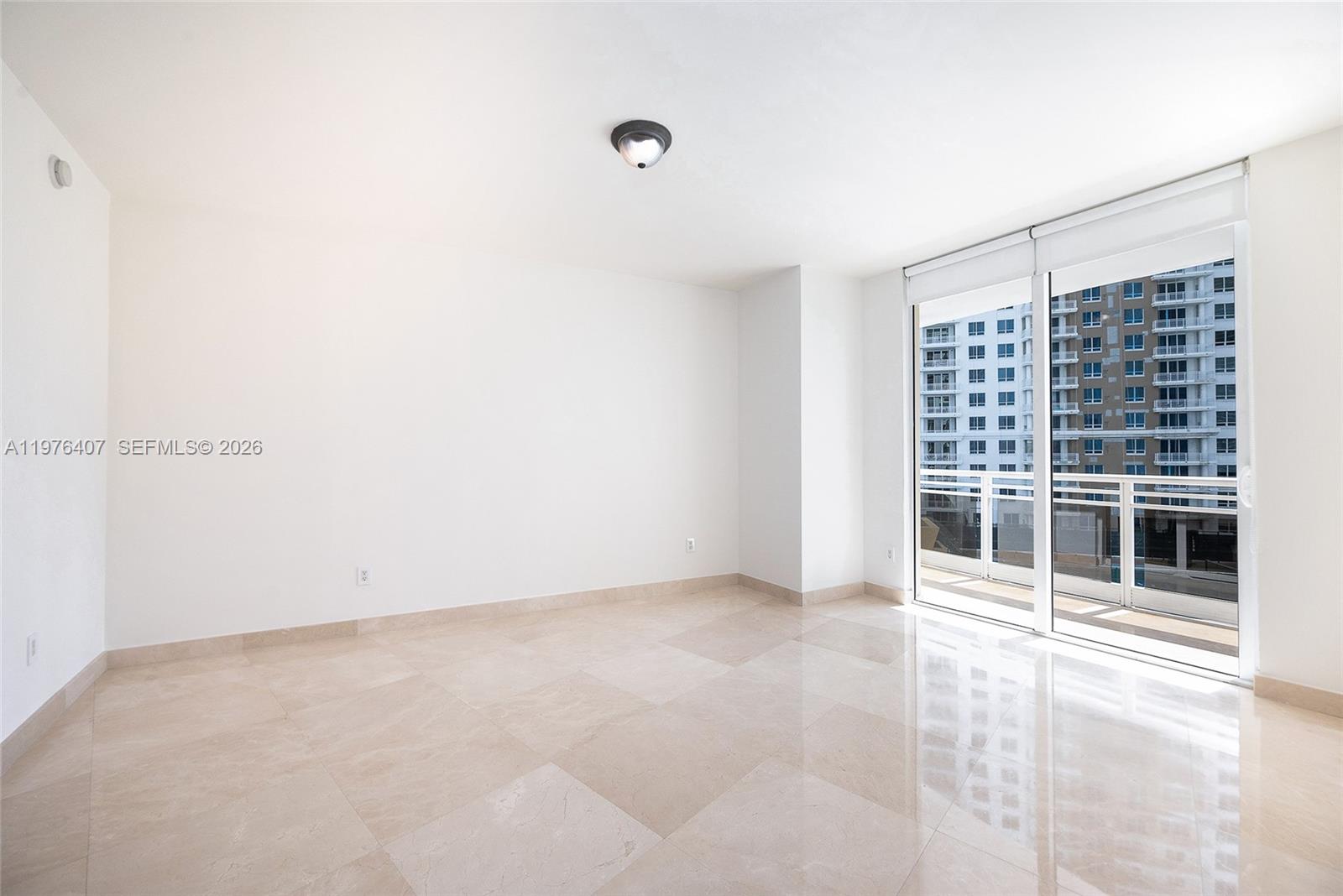 901 Brickell Key Boulevard, Unit 901 Miami, FL 33131 - Photo 8 of 35 a view of an empty room with a window