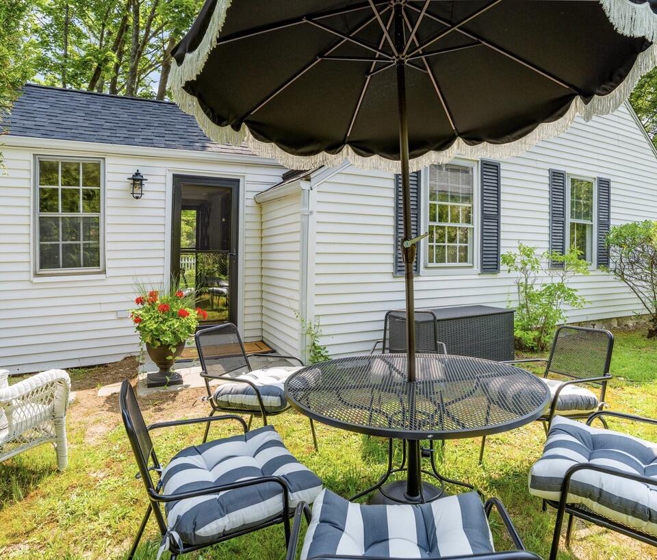 4 Dunaskin Road Centerville, MA 02632 - Photo 4 of 27 a view of table and chairs under an umbrella