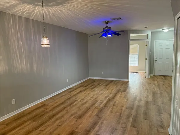 a very nice looking room with a ceiling fan and a window