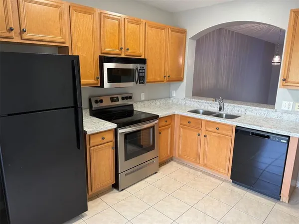 a kitchen with a sink stove and microwave