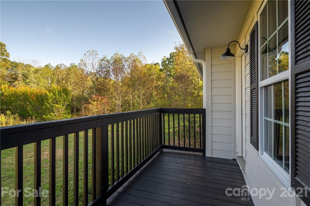 1401 Locust Grove Road Hendersonville, NC 28792 - Photo 4 of 20 a balcony with wooden floor and fence