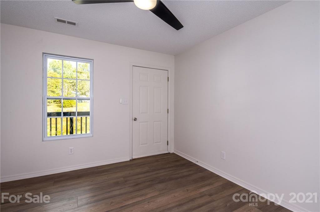 1401 Locust Grove Road Hendersonville, NC 28792 - Photo 8 of 20 an empty room with wooden floor and windows