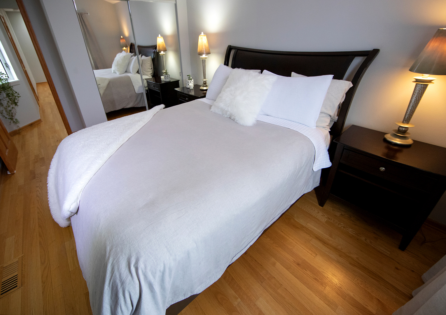 8316 High Point Circle, Unit F Darien, IL 60561 - Photo 18 of 24 a bed sitting in a bedroom next to a lamp