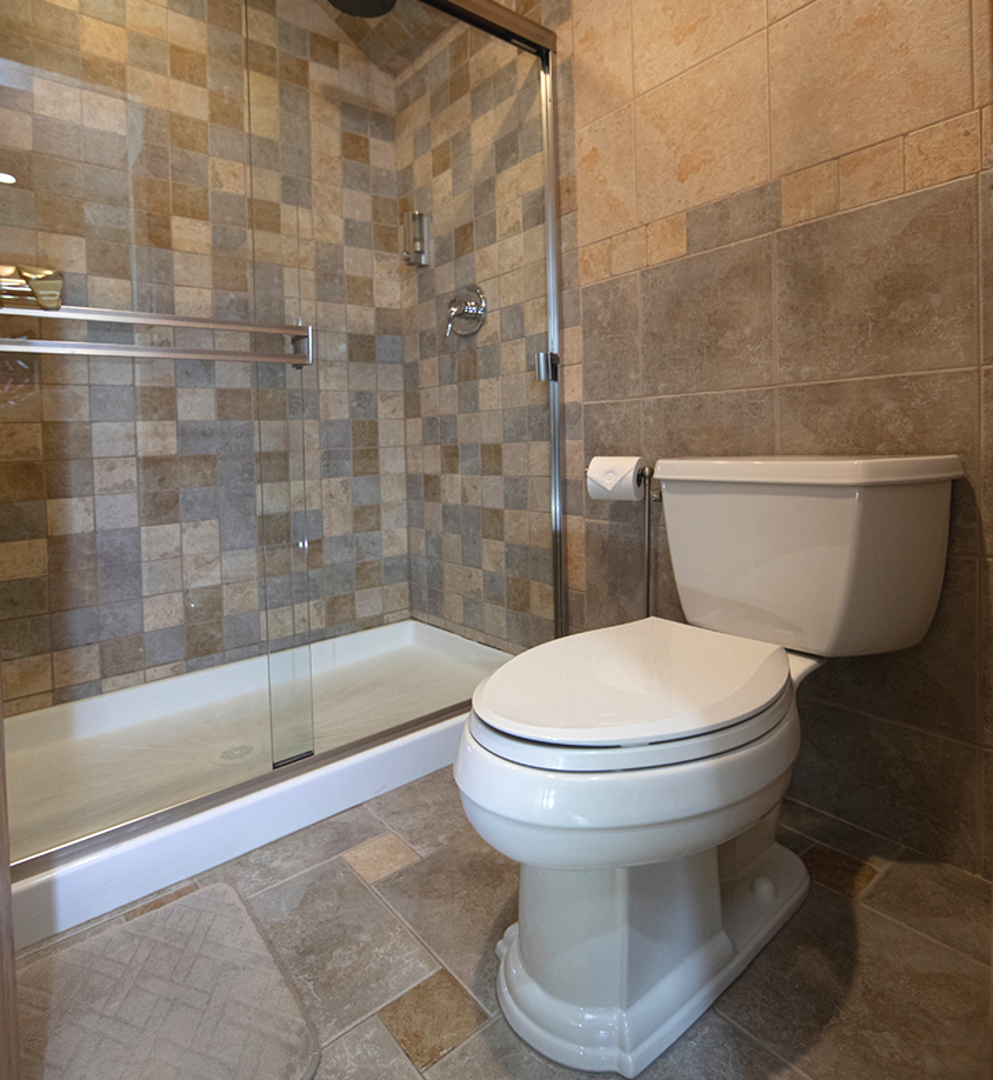 8316 High Point Circle, Unit F Darien, IL 60561 - Photo 19 of 24 a bathroom with a white toilet and a bathtub