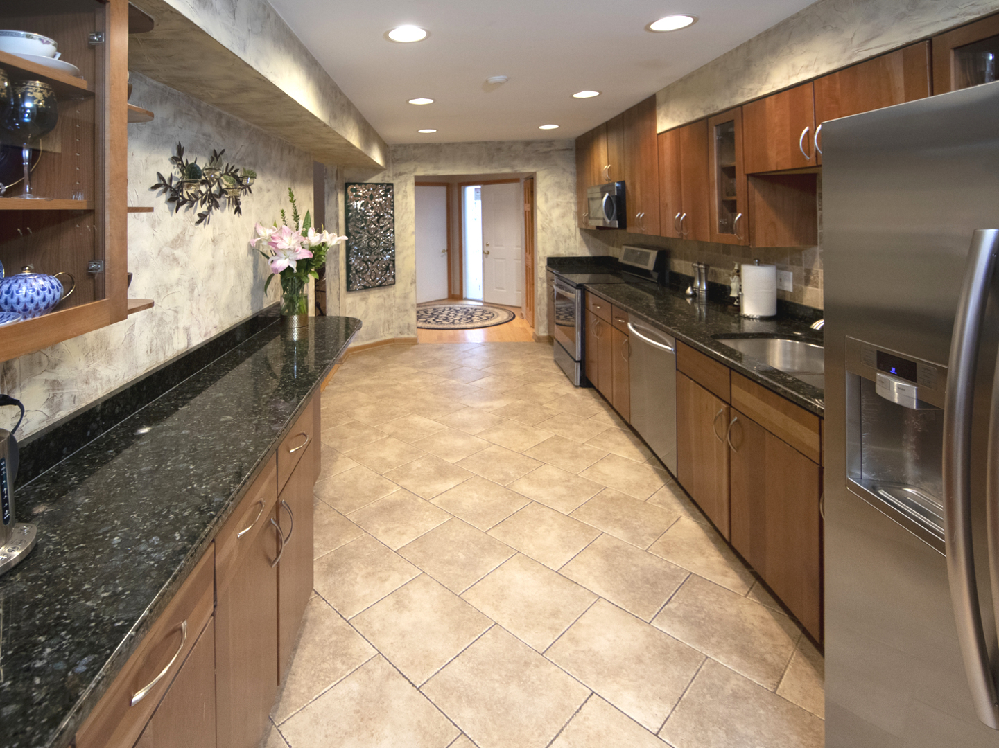 8316 High Point Circle, Unit F Darien, IL 60561 - Photo 8 of 24 a large kitchen with kitchen island a large counter top cabinets and stainless steel appliances