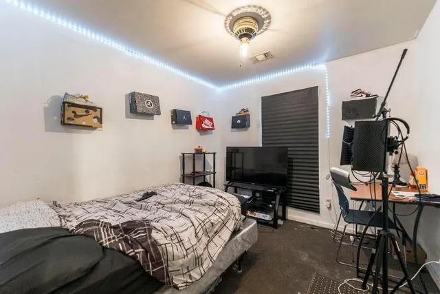 a large bed sitting in a bedroom next to a window