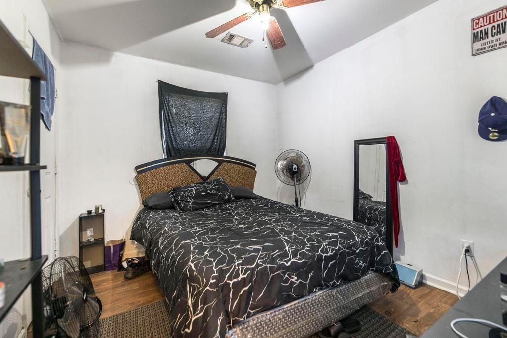 210 Perry Railroad Street Fort Valley, GA 31030 - Photo 13 of 45 a large bed sitting in a bedroom next to a window