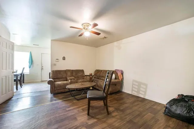 a view of a kitchen with furniture and wooden floor