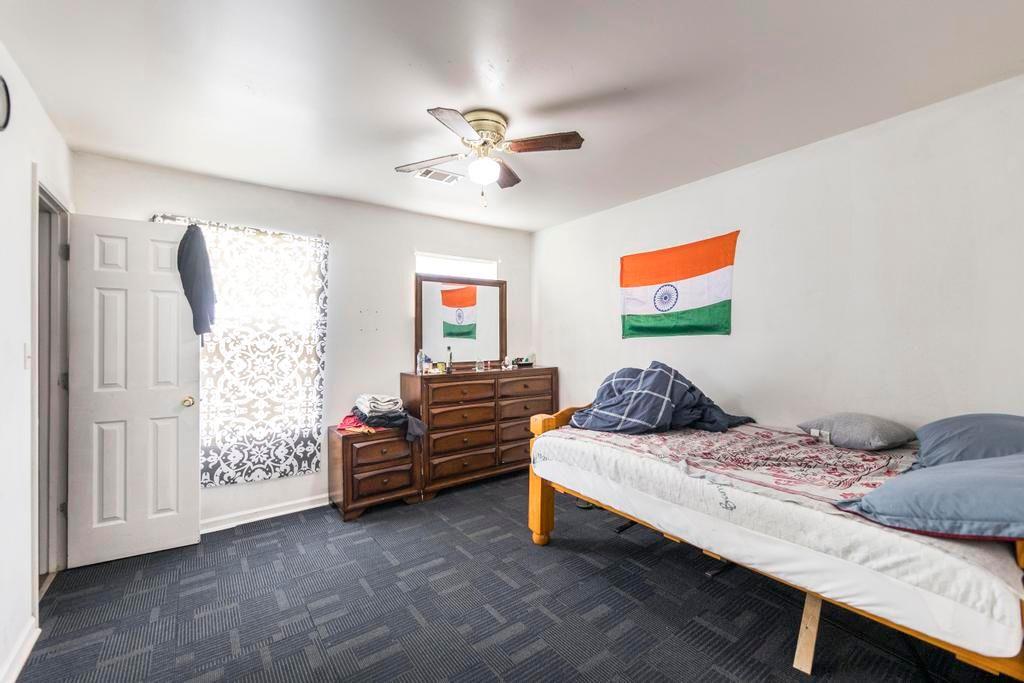 210 Perry Railroad Street Fort Valley, GA 31030 - Photo 18 of 45 a bedroom with a bed and a chandelier