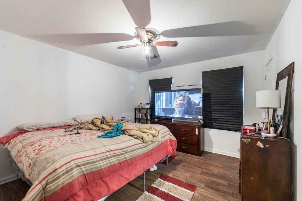 210 Perry Railroad Street Fort Valley, GA 31030 - Photo 19 of 45 a bedroom with a bed and dresser with mirror