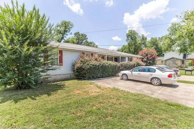 a view of a house with backyard and sitting area