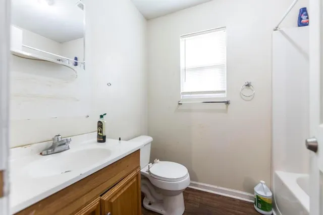 a bathroom with a sink toilet and mirror