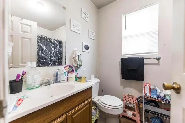 a bathroom with a sink toilet and mirror