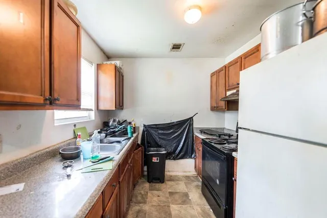 a kitchen with stainless steel appliances a refrigerator and a sink