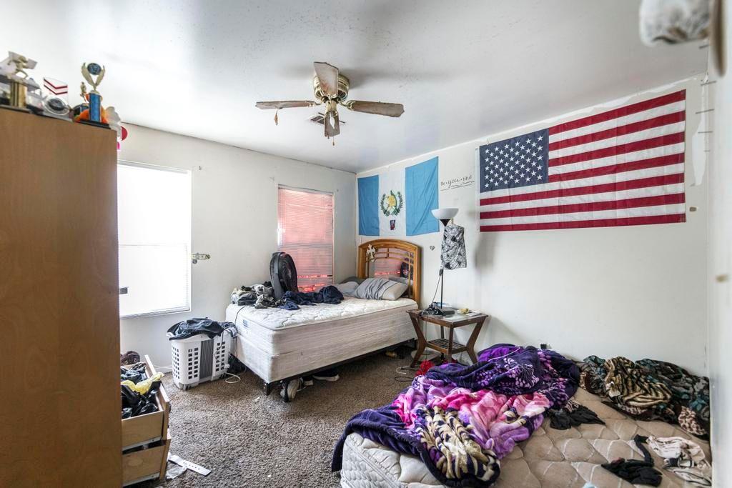 210 Perry Railroad Street Fort Valley, GA 31030 - Photo 40 of 45 a bedroom with bed and a chandelier