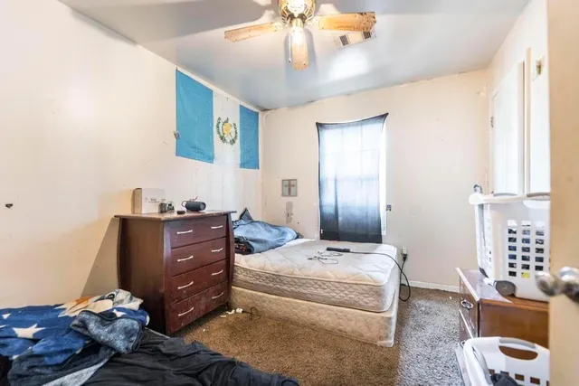 a view of backyard of house with green space