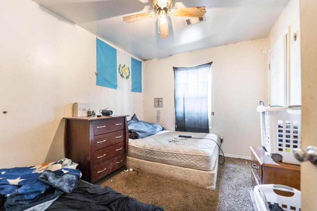 210 Perry Railroad Street Fort Valley, GA 31030 - Photo 41 of 45 a bedroom with a bed and wooden floor