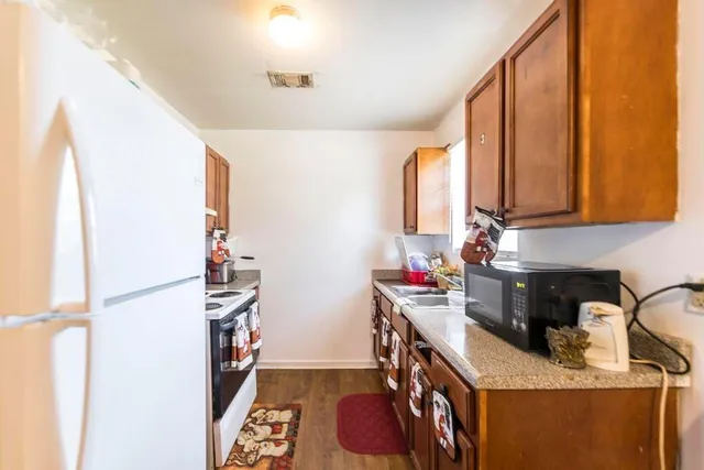 a kitchen with granite countertop a sink and a window