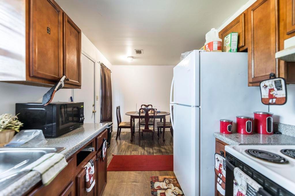 210 Perry Railroad Street Fort Valley, GA 31030 - Photo 7 of 45 a kitchen with stainless steel appliances granite countertop a refrigerator and a stove