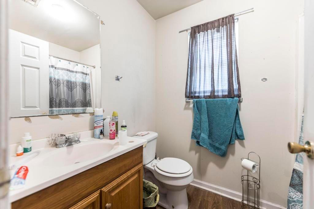 210 Perry Railroad Street Fort Valley, GA 31030 - Photo 10 of 45 a bathroom with a sink toilet and mirror