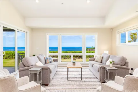 a living room with furniture and large windows