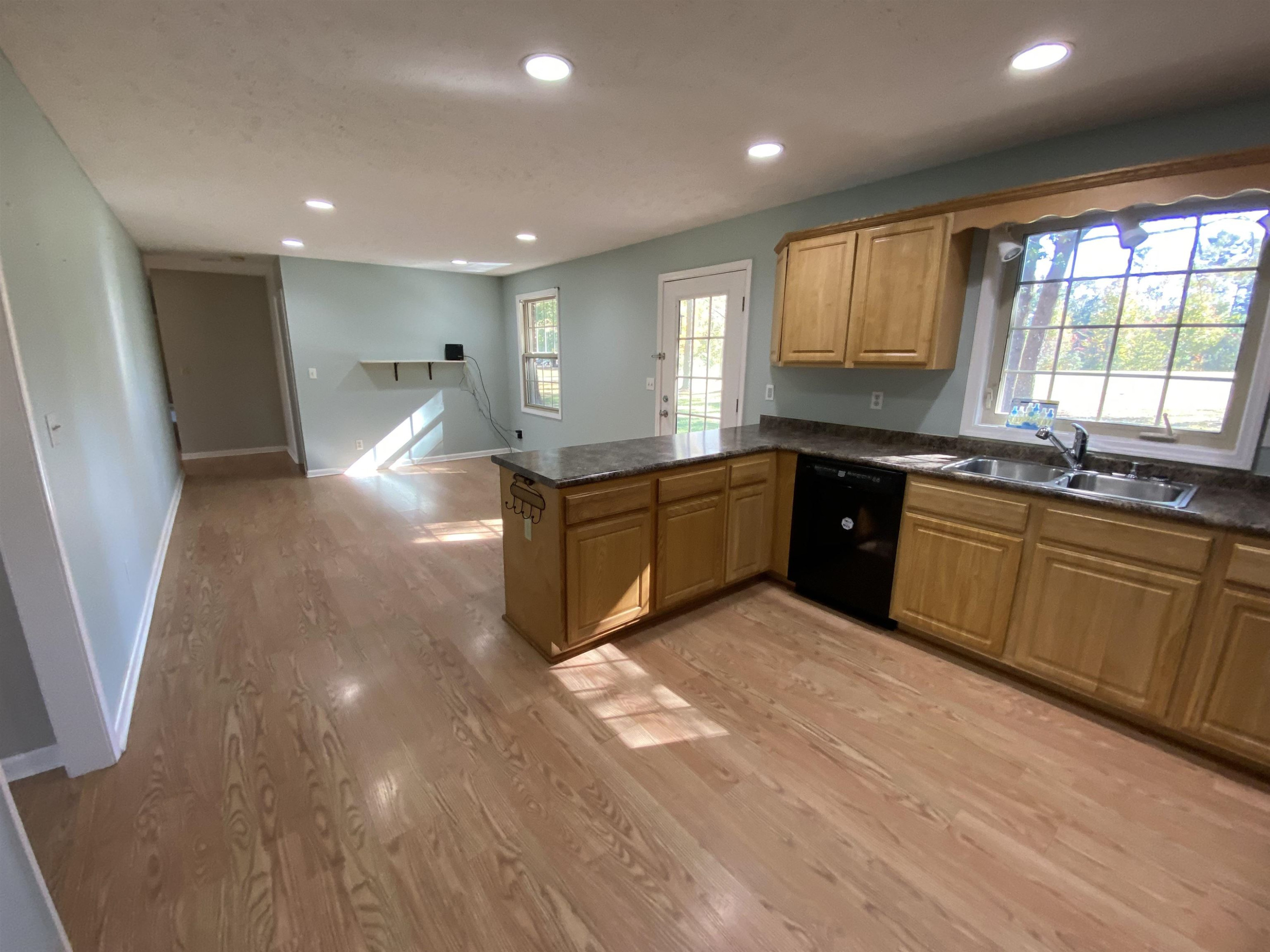 610 Old Finger Road Henderson, TN 38340 - Photo 15 of 24 a large kitchen with stainless steel appliances granite countertop a sink and cabinets with wooden floor