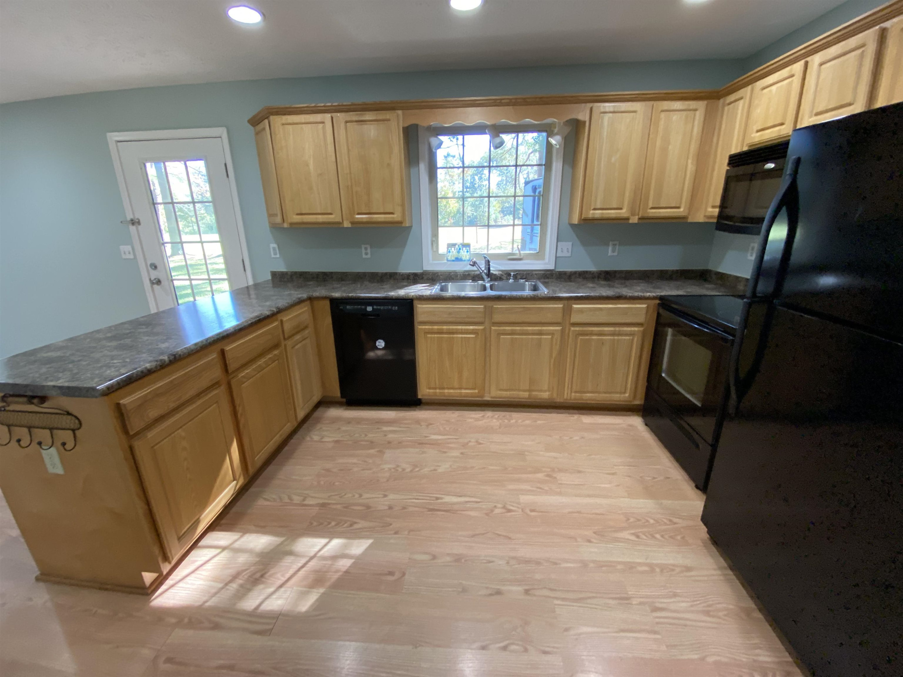 610 Old Finger Road Henderson, TN 38340 - Photo 16 of 24 a kitchen with granite countertop a refrigerator and a sink