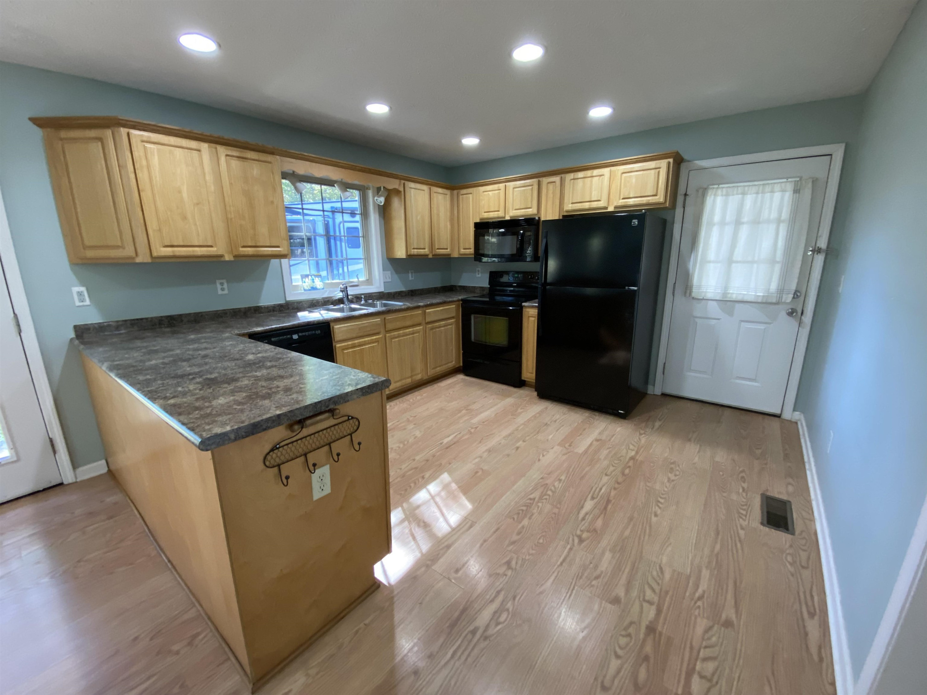 610 Old Finger Road Henderson, TN 38340 - Photo 18 of 24 a kitchen with granite countertop a refrigerator and a sink