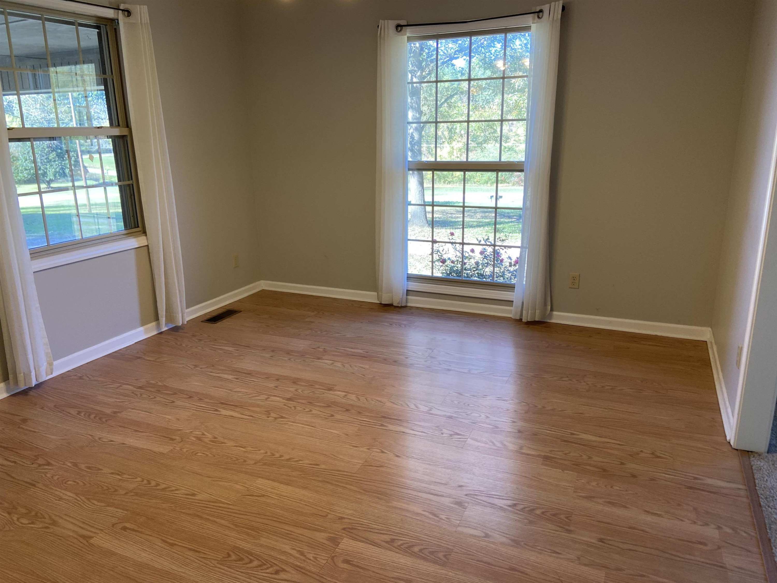 610 Old Finger Road Henderson, TN 38340 - Photo 6 of 24 a view of an empty room with wooden floor and a window